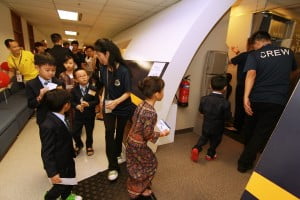 Children donning the SIA cabin crew uniform