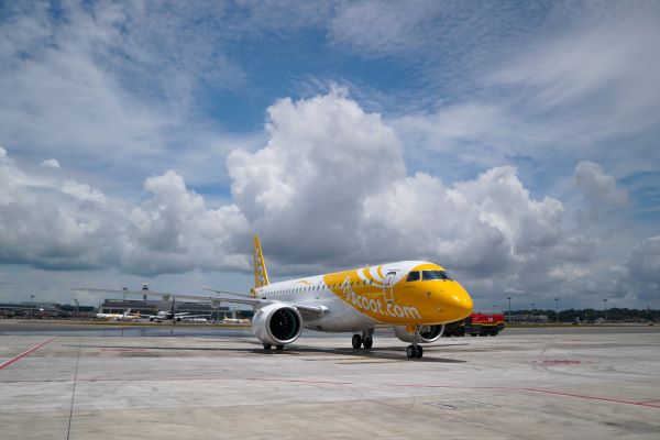 Scoots E190 E2 aircraft parked at a remote bay